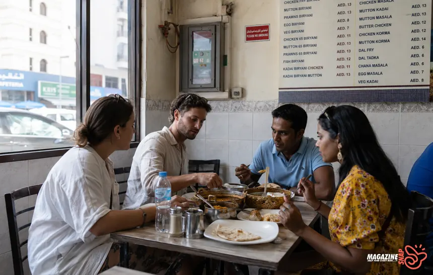 Travelers eating affordable local food inside a casual Bur Dubai restaurant with visible AED pricing.