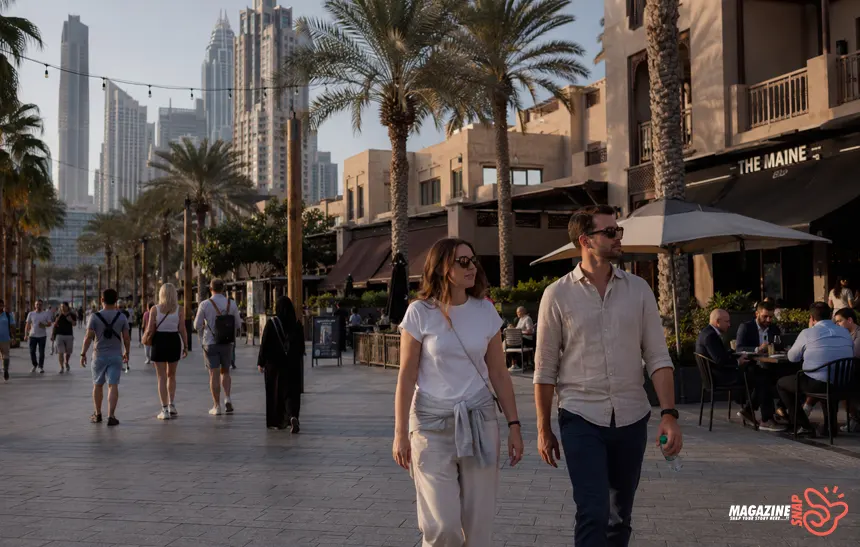 People walking through a Dubai residential neighborhood during mild winter weather with modern apartments and cafés nearby.