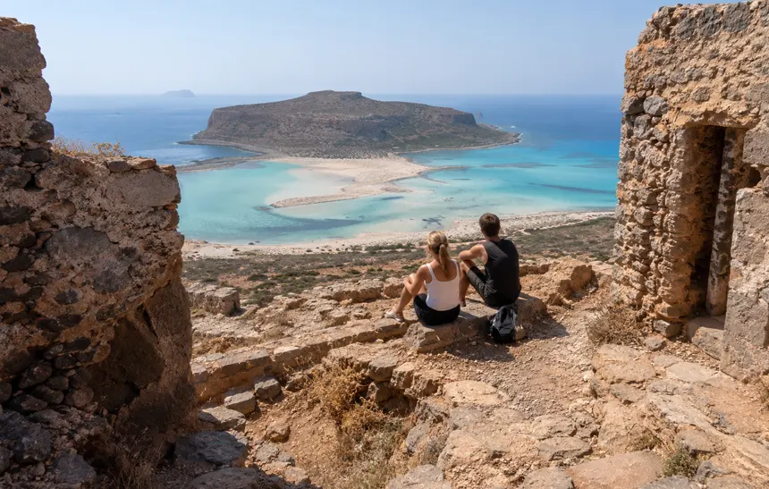 Travelers inside the Venetian fortress on Gramvousa overlooking Balos Lagoon in Crete.