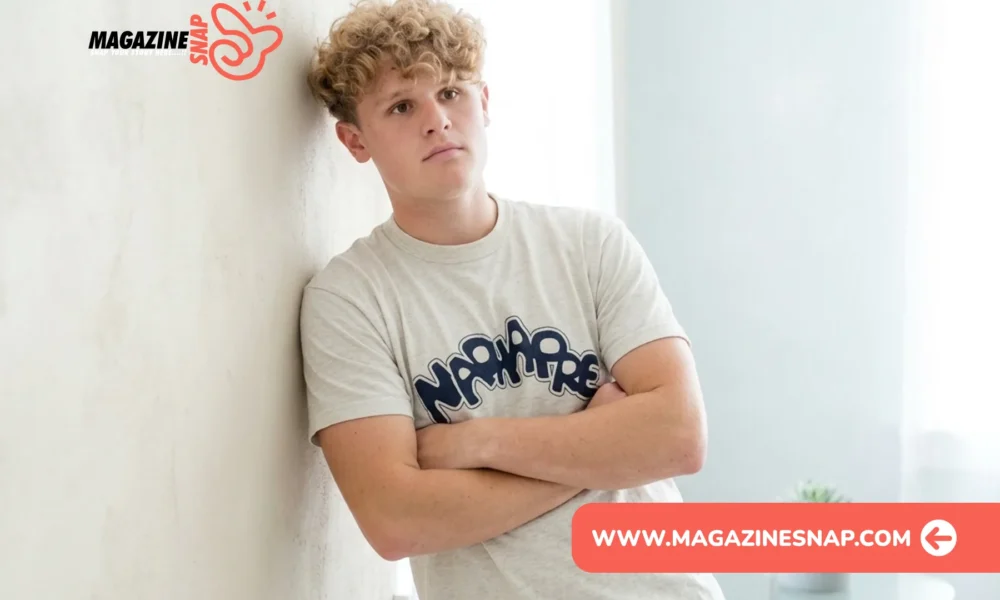 Ryan Trahan net worth feature image with creator leaning against a wall in casual clothing