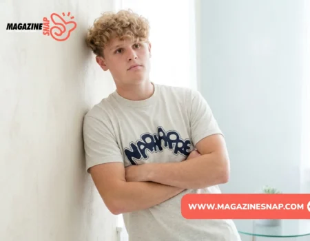 Ryan Trahan net worth feature image with creator leaning against a wall in casual clothing