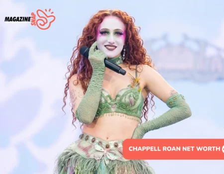 Chappell Roan performing live in green stage makeup and feathered costume