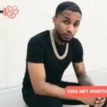 DDG net worth 2025 portrait, rapper in black tee and diamond chain seated outdoors