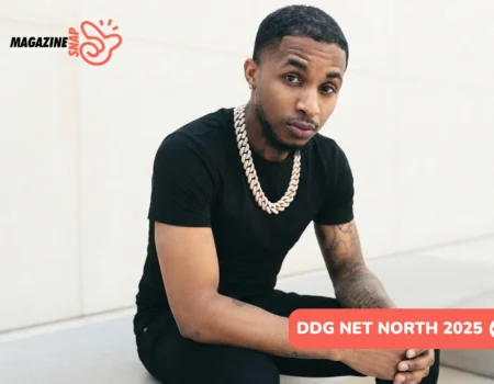 DDG net worth 2025 portrait, rapper in black tee and diamond chain seated outdoors