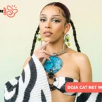 Doja Cat in zebra-print off-shoulder top with turquoise statement necklace