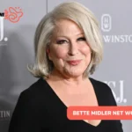 Bette Midler at a media event in a black top, pictured for the Bette Midler net worth article