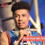 Blueface performing on stage in a jersey and gold chains for the Blue Face net worth article