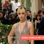 Camila Cabello net worth photo: sequined gown, red carpet, updo hairstyle.