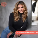 Eleonora Srugo net worth article portrait, seated in a photography studio in jeans