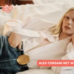 Alex Consani Net Worth in a white shirt and denim overalls, featured for the Alex Consani article.