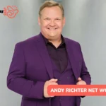 Andy Richter Net Worth - the comedian and actor smiling in a purple three-piece suit