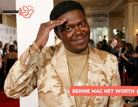 Bernie Mac net worth article portrait, smiling on a red carpet in a patterned blazer
