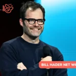 Bill Hader smiling with a microphone on stage, image for the Bill Hader net worth article.