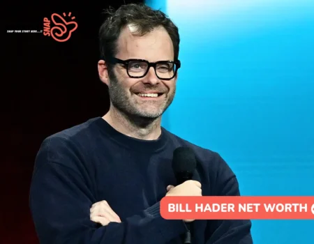 Bill Hader smiling with a microphone on stage, image for the Bill Hader net worth article.