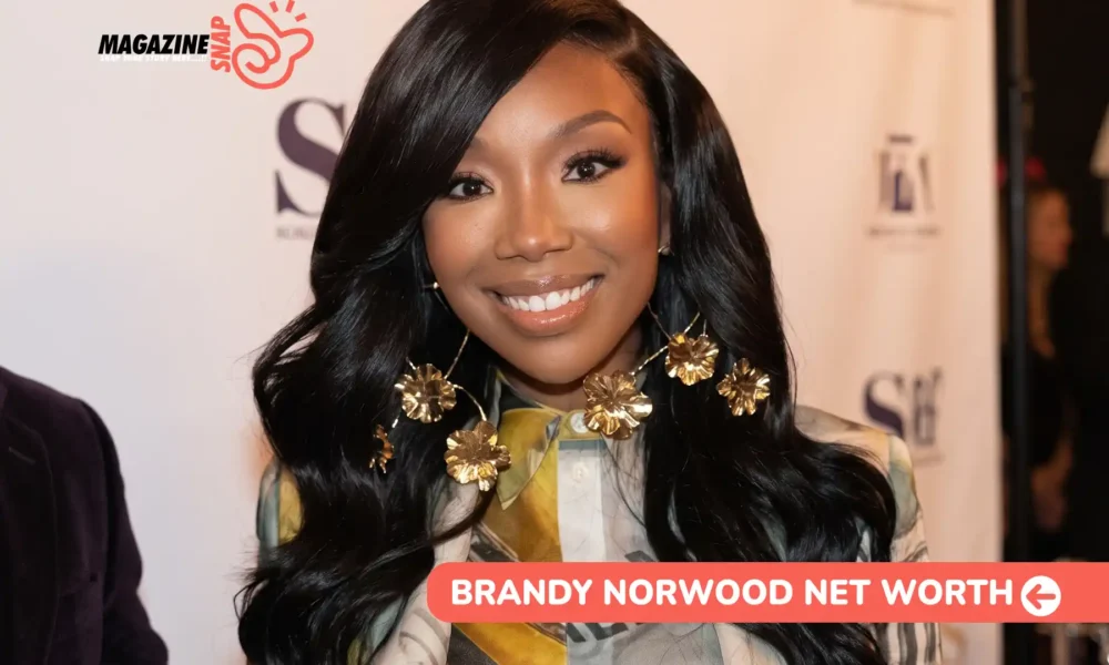 Brandy Norwood Net Worth 2026 – $10M Estimate, Walk of Fame Star Brandy Norwood smiling at an event backdrop, photographed for the Brandy Norwood net worth article.