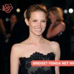 Bridget Fonda net worth article: she smiles in a black strapless lace dress at a night event