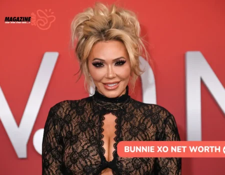 Blonde-haired Bunnie Xo smiling in a black lace top against a red backdrop, for Bunnie Xo net worth article