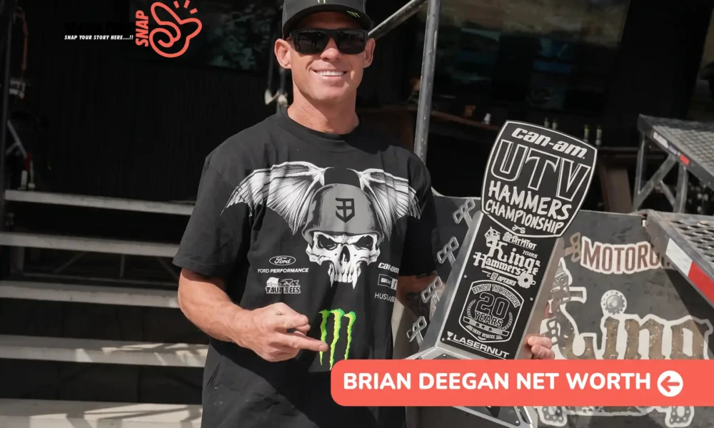 Deegan in a Monster Energy cap and sunglasses holding a 2nd Stock trophy for the Brian Deegan net worth article