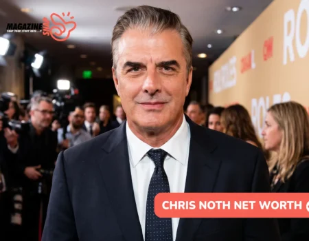 Chris Noth in a navy suit and polka-dot tie on a red carpet for Chris Noth net worth article, photographers behind