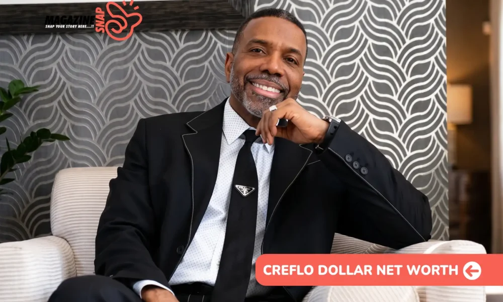 Creflo Dollar Net Worth 2026 – $30M Estimate, Senior Pastor Creflo Dollar net worth article portrait of him smiling in a black suit and tie, seated in a striped armchair